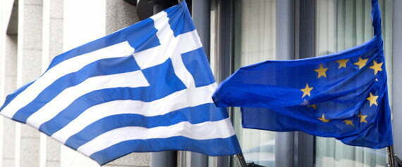 The Greek, left, and EU flag flap in the wind outside the Greek embassy in Brussels on Friday, Feb. 20, 2015. Eurozone finance ministers meet for a crucial day of talks to see whether a Greek debt relief proposal is acceptable to Germany and other nations using the common currency. (AP Photo/Virginia Mayo)